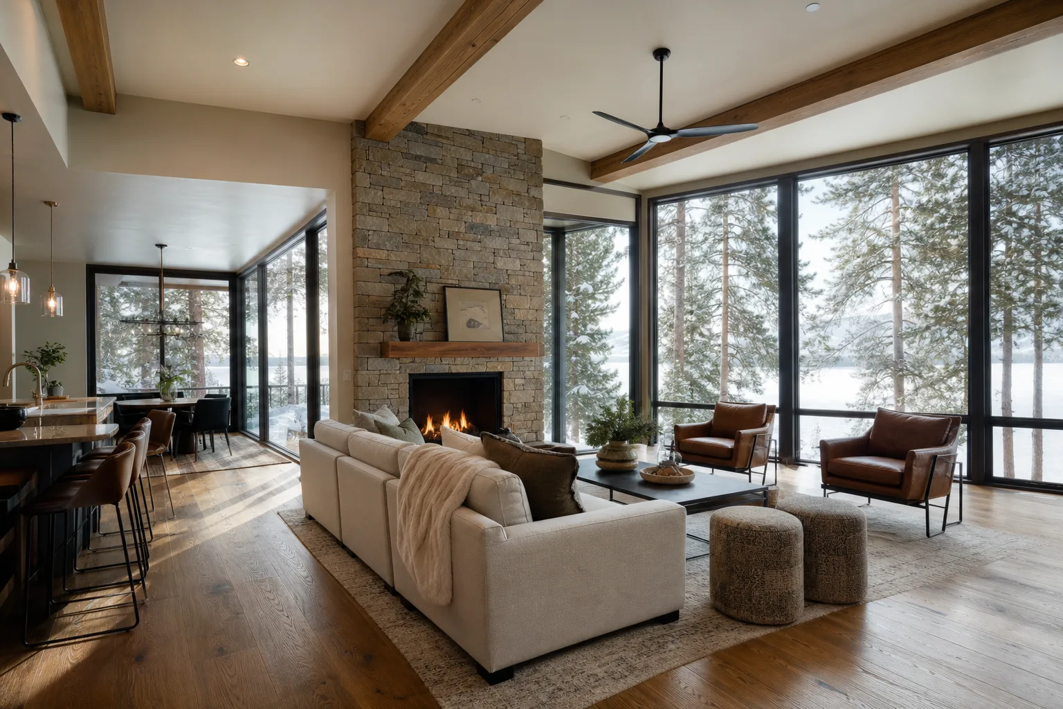 Warm North Idaho living room with hardwood floors and large windows looking out to snow-dusted pines, the kind of space radiant heat warms evenly